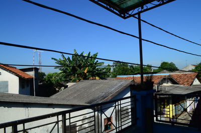 Low angle view of houses against blue sky