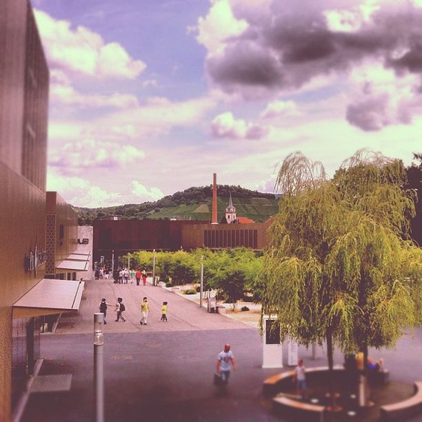 sky, tree, cloud - sky, architecture, built structure, building exterior, cloud, cloudy, indoors, table, city, growth, glass - material, incidental people, day, potted plant, sunlight, nature, street light