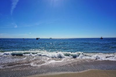 Scenic view of sea against blue sky