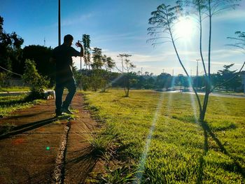 Man playing soccer on field against sky