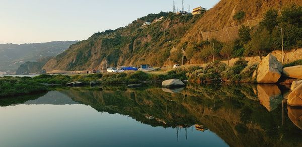 Scenic view of lake and mountains against sky