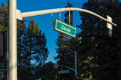 Low angle view of road sign against sky