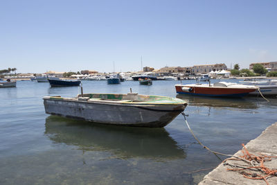 Boats moored in marzamemi harbor