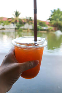 Close-up of hand holding drink drinking glass