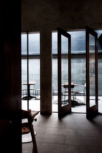 Empty chairs and tables in building