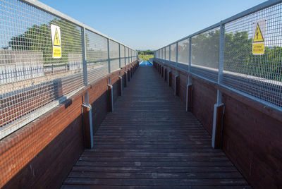 View of footbridge against clear sky