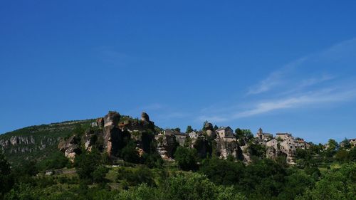 Scenic view of mountain against blue sky