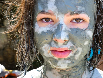 Close-up portrait of girl with facial mask on face