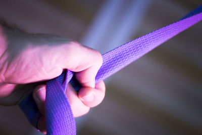 Cropped hand holding strap in gym