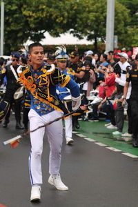 A man wearing traditional clothes in  marching band