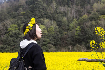 Woman with yellow flower crown in field