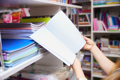 Midsection of woman reading book