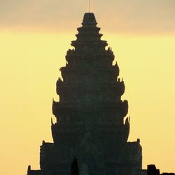 Low angle view of built structure at sunset