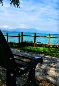 Railing by sea against sky