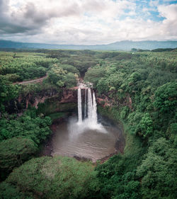 Scenic view of waterfall against sky