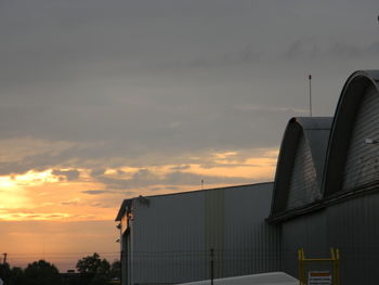 Factory against sky during sunset