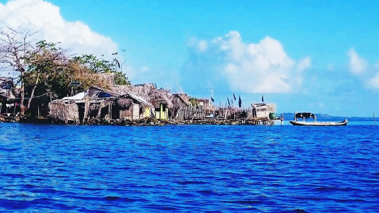 water, sea, waterfront, blue, sky, built structure, architecture, cloud - sky, building exterior, cloud, tranquil scene, tranquility, rippled, nature, scenics, outdoors, day, ocean, non-urban scene, no people, beauty in nature, solitude, coastline, remote