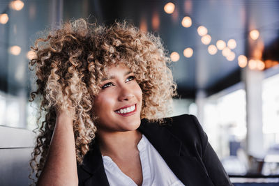 Portrait of happy confident business woman daydreaming in cafe. business concept