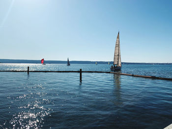 Sailboat on sea against clear sky