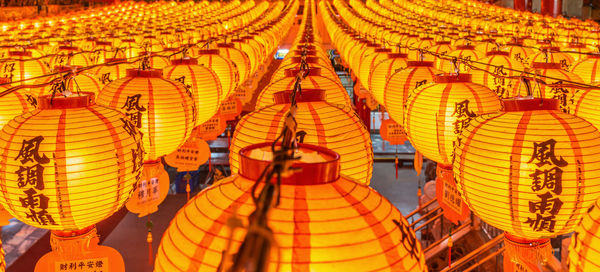 Low angle view of illuminated lanterns hanging outside building