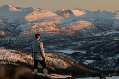 Rear view of man looking at mountains