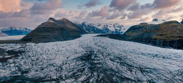 Beautiful glaciers flow through the mountains in iceland.