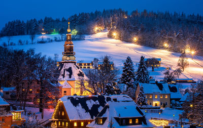 Illuminated buildings in city at night