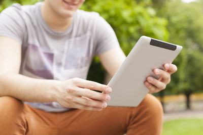 Midsection of man using mobile phone