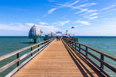 Pier over sea against sky