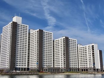 Low angle view of modern buildings against sky in city