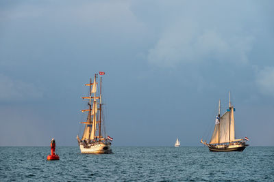 Sailboat sailing on sea against sky