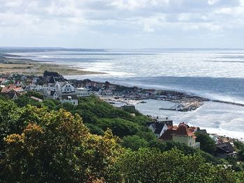 High angle view of sea and buildings against sky