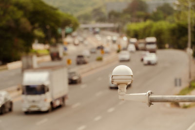 Close-up of vehicles on road in city