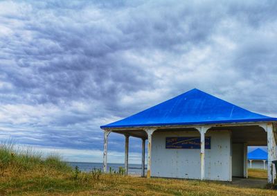 Built structure on field against sky