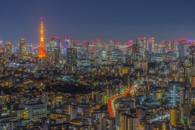 Illuminated cityscape against sky at night