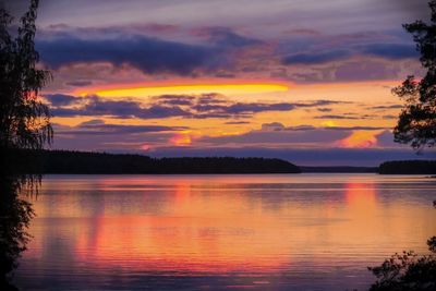 Scenic view of lake against romantic sky at sunset