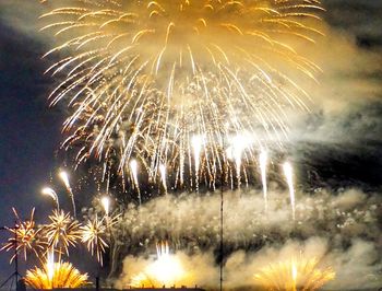 Low angle view of firework display at night