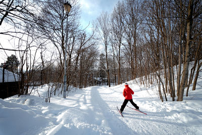 Man on snowy field against sky during winter