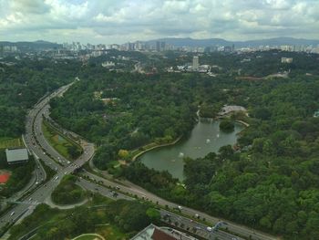 High angle view of river amidst cityscape against sky