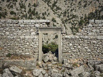 Old stone wall by rocks