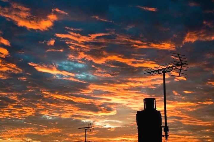 sunset, low angle view, sky, silhouette, orange color, cloud - sky, cloudy, cloud, dramatic sky, street light, beauty in nature, nature, scenics, tranquility, pole, fuel and power generation, no people, power line, technology, outdoors