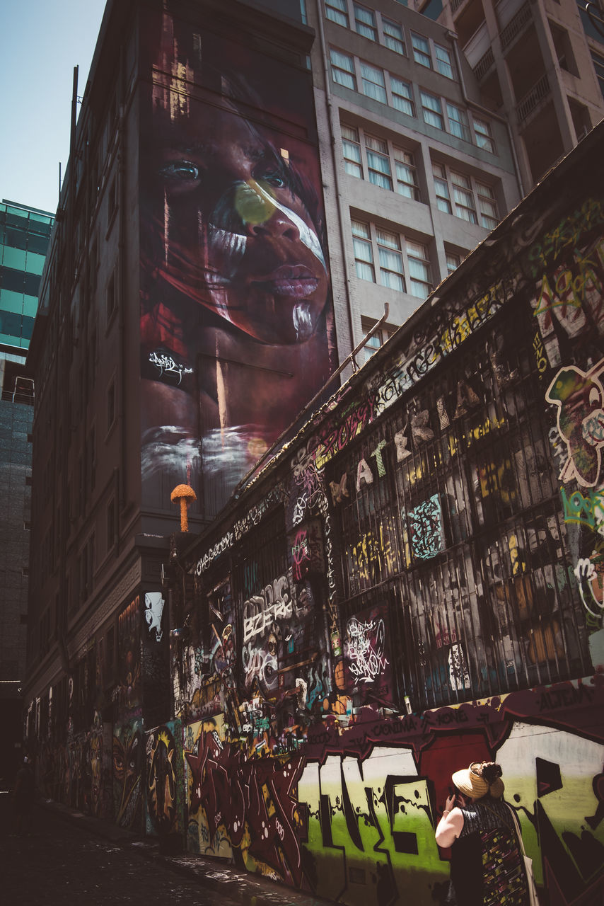 PEOPLE ON STREET AMIDST BUILDINGS