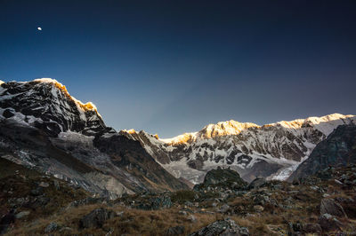 Scenic view of snowcapped mountains against clear sky