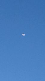 Scenic view of moon against blue sky