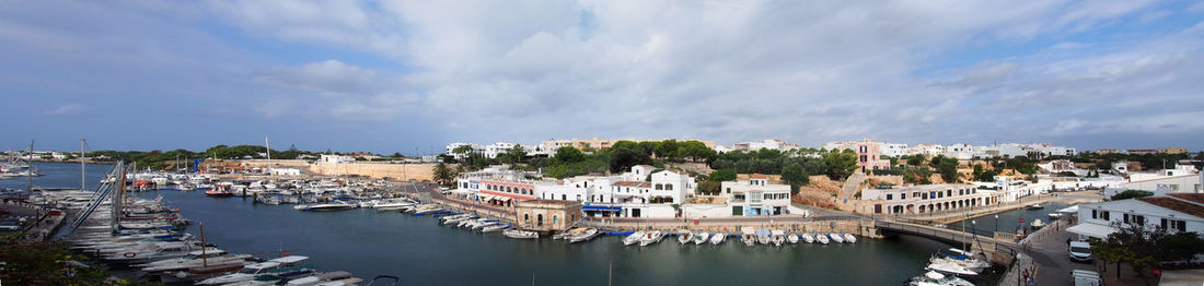 High angle view of townscape by river against sky