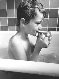 Close-up of shirtless boy in bathroom