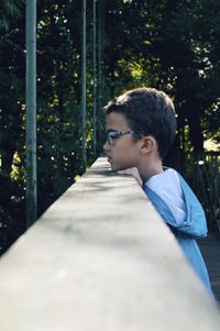 Portrait of boy wearing hat on tree