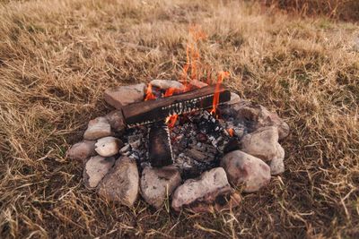 Heap on barbecue grill in field