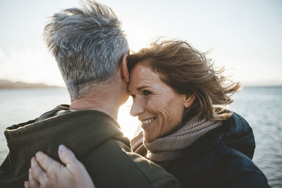 Happy mature couple embracing each other at beach