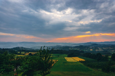 Scenic view of field against sky during sunset